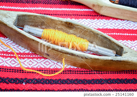weaving loom and shuttle on the warp. weaving loom and shuttle on the warp. 25141160