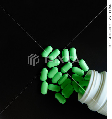 Overhead closeup view of pill bottle with green 25144100