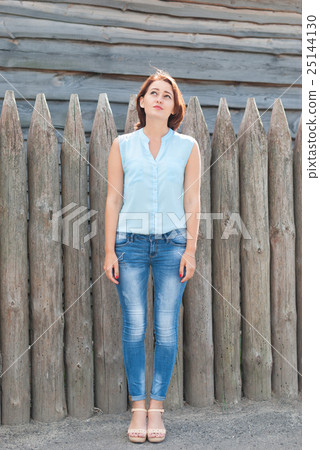 Young beautiful girl looking to the top . Young beautiful girl looking to the top . 25144130