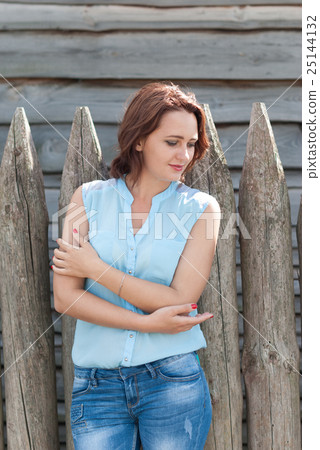 Beautiful girl on the background a wooden fence. Beautiful girl on the background a wooden fence. 25144132