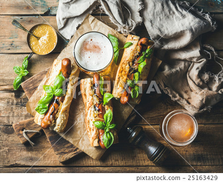 Wheat unfiltered beer and grilled sausage dogs in 25163429