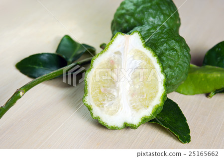 Bergamot fruit with leaf on wooden board Bergamot fruit with leaf on wooden board 25165662