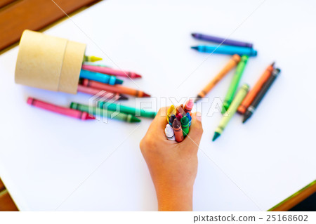 child's hands with lots of colorful wax crayons child's hands with lots of colorful wax crayons 25168602