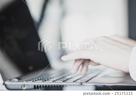 Female hands typing on a laptop 25171115