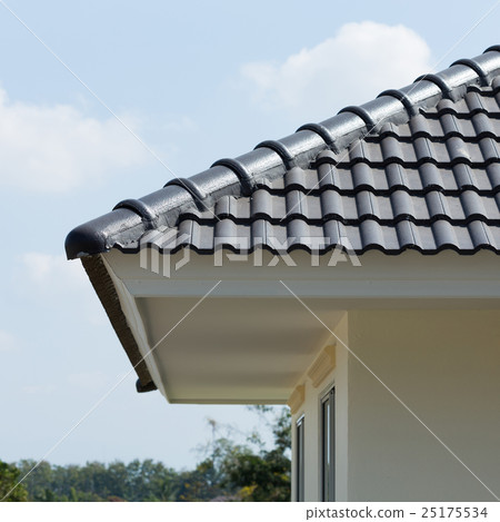 black roof tiles on house with blue sky 25175534