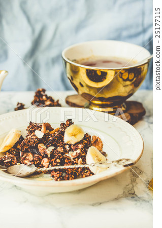 Homemade chocolate granola with banana, peanut Homemade chocolate granola with banana, peanut 25177115