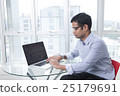 Focused businessman working at laptop in office 25179691