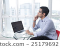 Serious businessman thinking at desk 25179692