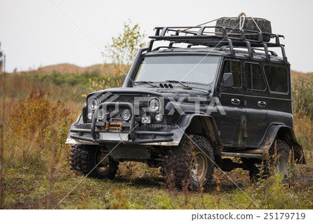 Russian black off road car UAZ in a meadow Russian black off road car UAZ in a meadow 25179719