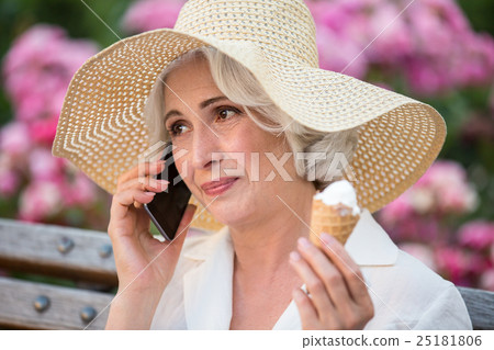 Mature woman with cell phone. Mature woman with cell phone. 25181806