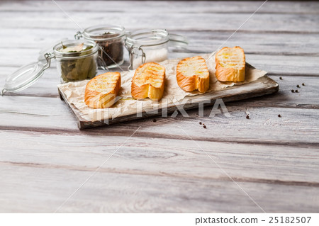 Sliced baguette on board. 25182507