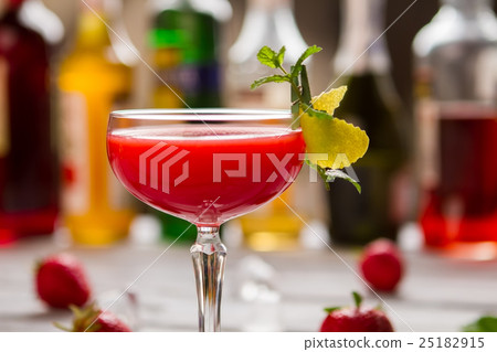 Red beverage in coupe glass. 25182915