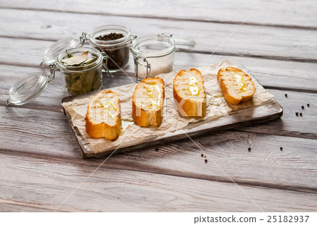 Slices of bread with oil. 25182937