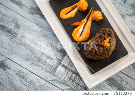 Cooked meat and sauce. 25183276