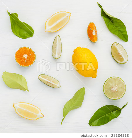 Mixed fresh citrus fruits and leaves background. 25184318