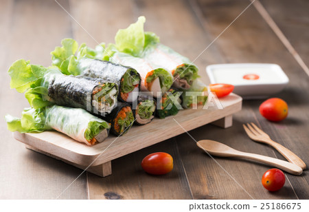 salad roll on wood plate 25186675