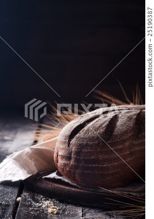 wheat and bread on a wooden table wheat and bread on a wooden table 25190387