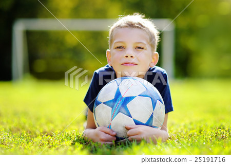 Little boy having fun playing a soccer game Little boy having fun playing a soccer game 25191716