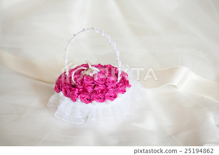 Golden wedding rings on decorated little purple Golden wedding rings on decorated little purple 25194862