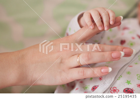 Son and mother, baby holding moms finger. Family Son and mother, baby holding moms finger. Family 25195435