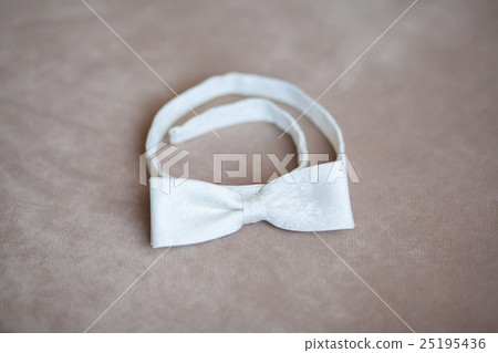 White wedding bow tie on gray background White wedding bow tie on gray background 25195436