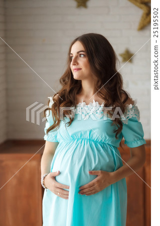 Pregnant woman touching her belly with hands Pregnant woman touching her belly with hands 25195502