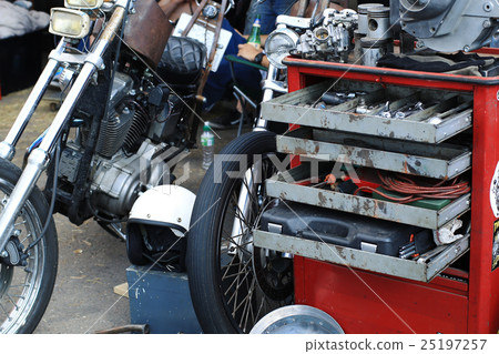 Old garage for a motorcycle repair with the tool b 25197257