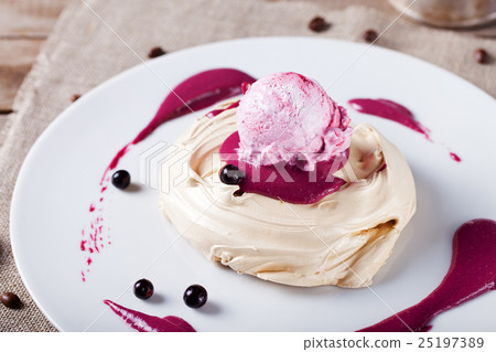 Meringue with berry ice cream on a white plate 25197389