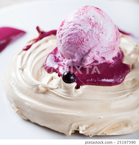 Meringue with berry ice cream on a white plate 25197390