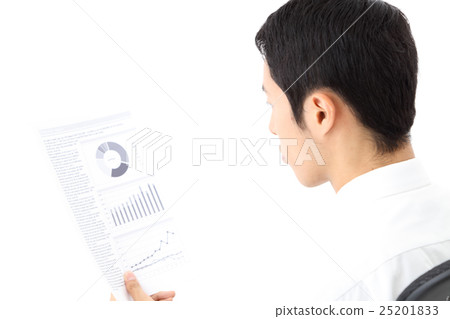 A businessman looking at a document A businessman looking at a document 25201833
