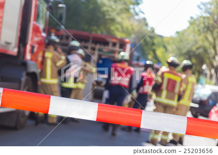 Team of firefighters by firetruck on accident 25203656