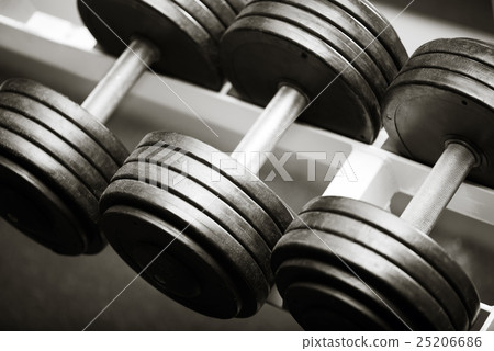 Three metal dumbbells lying in a row 25206686