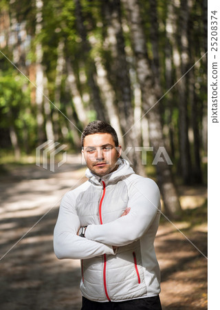 Handsome confident man jogging in a park 25208374