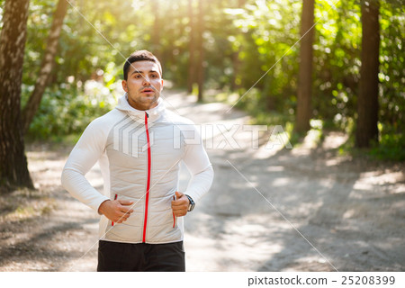 Pleasant young man doing morning run Pleasant young man doing morning run 25208399