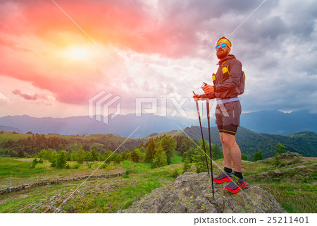 Man resting on top of the mountain during the practice of trail Man resting on top of the mountain during the practice of trail 25211401