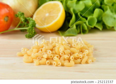 macaroni pasta close up  on wooden background 25211537