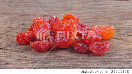 Sun-dried cocktail tomatoes on wood background Sun-dried cocktail tomatoes on wood background 25211558