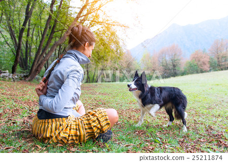 Girl playing with her dog border collie 25211874