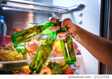 Man taking beer from a fridge 25215538