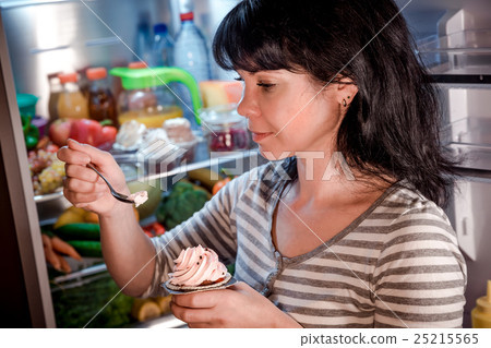 Woman eating unhealthy food from the fridge at night 25215565