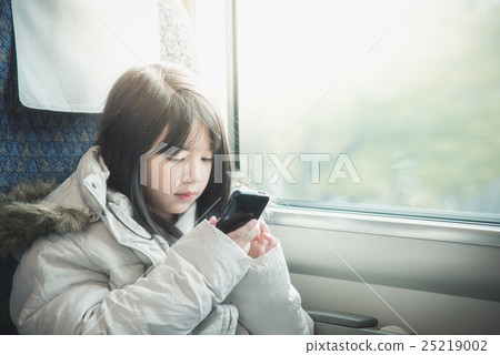 Little asian girl sharing social media in a smart phone Little asian girl sharing social media in a smart phone 25219002