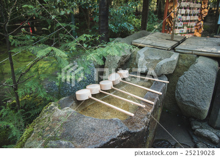 ladle on bamboo in japanese shrine 25219028