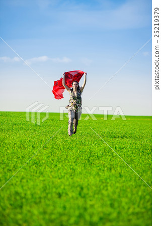 Beautiful young woman jumping on a green meadow Beautiful young woman jumping on a green meadow 25219379