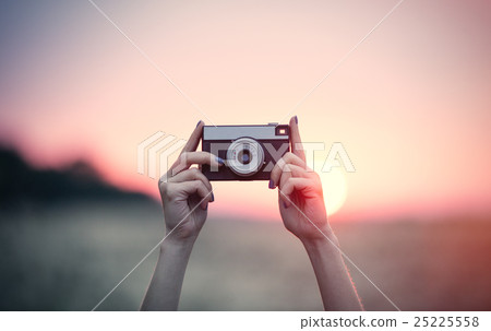 hands holding a camera hands holding a camera 25225558