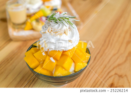 Korean style fresh mango shaved ice on wood table . Korean style fresh mango shaved ice on wood table . 25226214