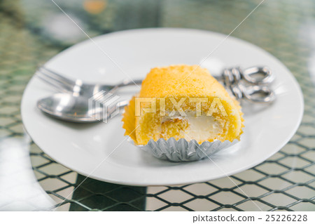 Cake roll butter cream on white plate . 25226228