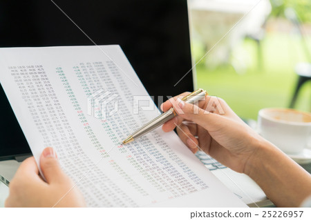 Business woman hand with Financial charts and laptop on the table . Business woman hand with Financial charts and laptop on the table . 25226957