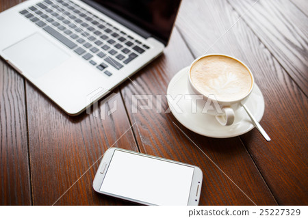 Mockup with laptop and smartphone on table in cafe Mockup with laptop and smartphone on table in cafe 25227329