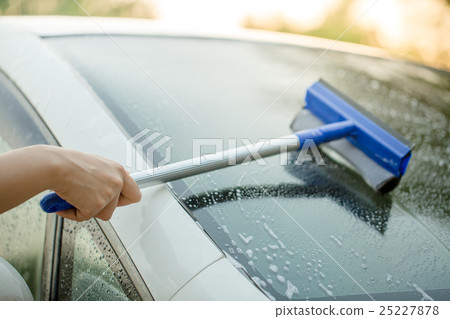 People cleaning car glass using cleaning brush 25227878
