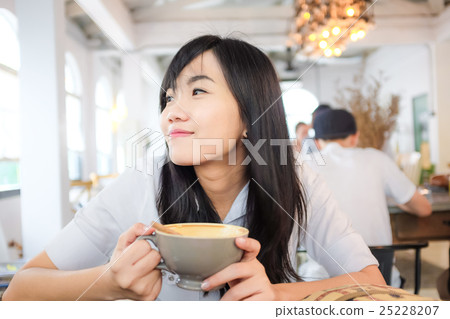 Smilling asian young woman hold coffee cup 25228207